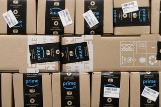A wall of Amazon packages with Prime Day labels