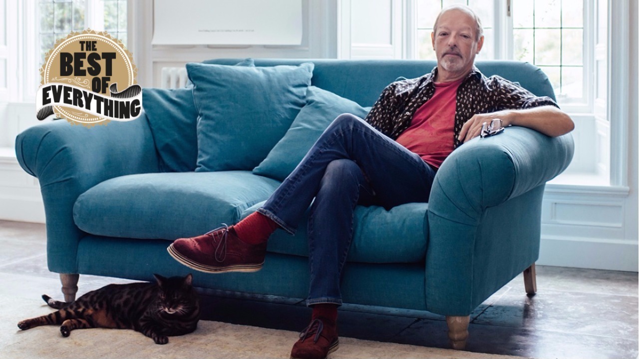 chris merrick hughes sitting on a sofa with a cat