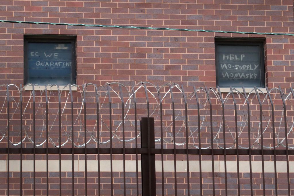 A window of a prison reads &amp;quot;Help, no supply no masks&amp;quot;