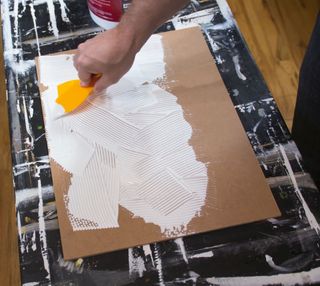 A toothed spreader spreading gesso