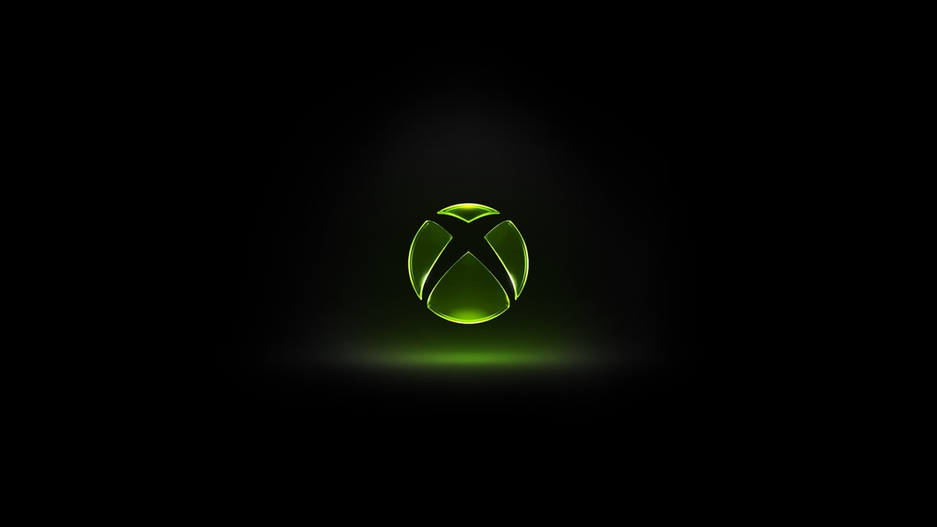 Xbox logo glowing green against a dark black background, centered with a soft light effect underneath, creating a dramatic and high contrast visual.