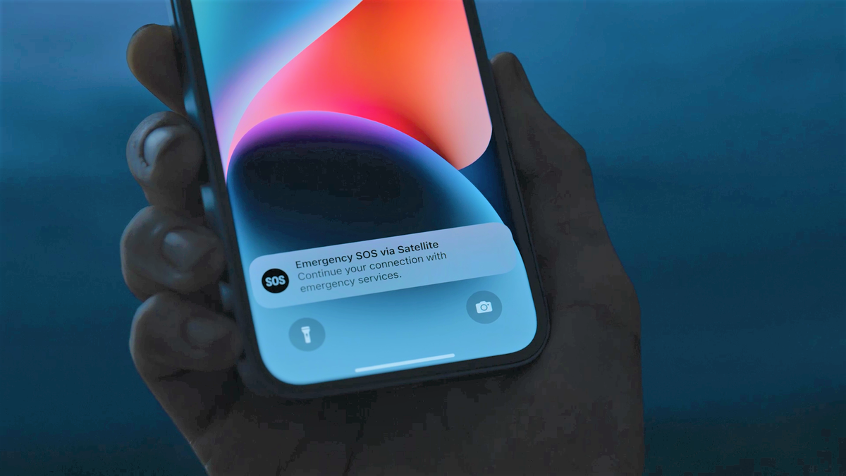 An iPhone 14 showing an alert for the Emergency SOS via Satellite feature.