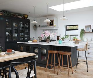 kitchen extension with dark blue kitchen units and white worktops