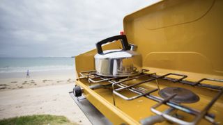 Double burner camping stove on beach