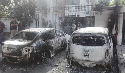 Burned out cars in Karachi, Pakistan near the Chinese consulate shooting