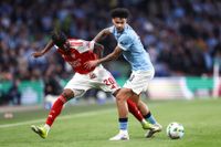 Nico O'Reilly battles for possession with Arsenal's Noni Madueke