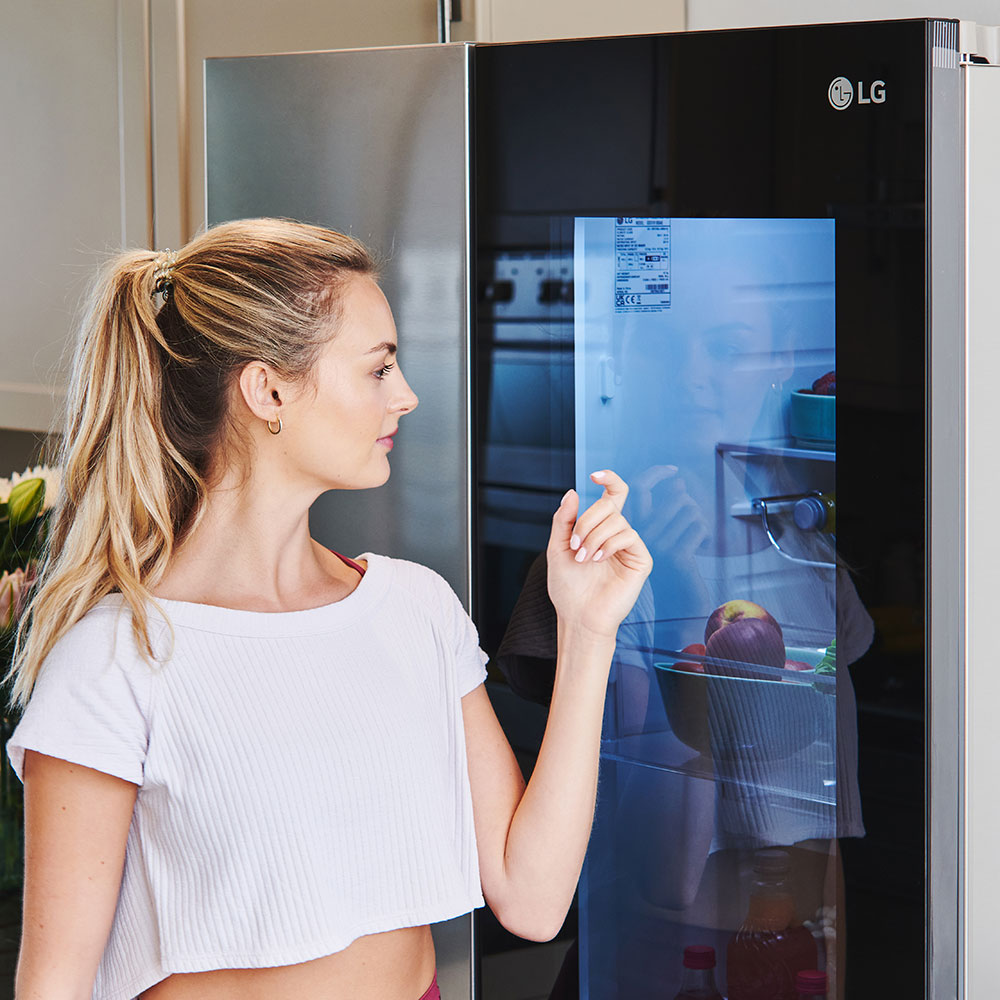 kitchen area with fridge with glass door