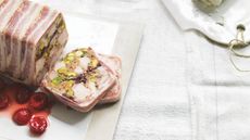 Chicken and pistachio terrine wrapped in bacon with pickled cherries on the side