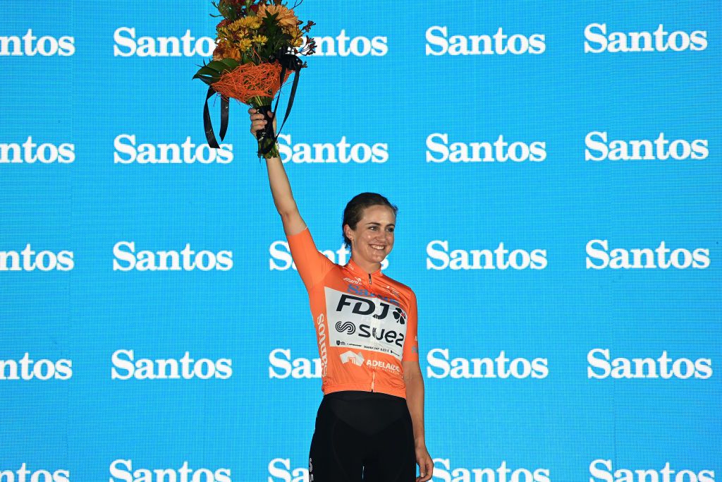 CAMPBELLTOWN AUSTRALIA JANUARY 17 Grace Brown of Australia and Team FDJSuez celebrates at podium as Orange Leader Jersey during the 7th Santos Womens Tour Down Under 2023 Stage 3 a 932km stage from Torrens Foot Bridge Adelaide to Montacute Road Campbelltown TourDownUnder UCIWWT on January 17 2023 in Campbelltown Australia Photo by Tim de WaeleGetty Images