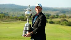 Dean Burmester holds the 2023 South African Open Championship trophy