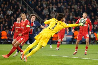 Liverpool's Brazilian goalkeeper #01 Alisson (C) dives to punch the ball during the UEFA Champions League Round of 16 first leg football match between Paris Saint-Germain (FRA) and Liverpool (ENG) at the Parc des Princes stadium in Paris on March 5, 2025.