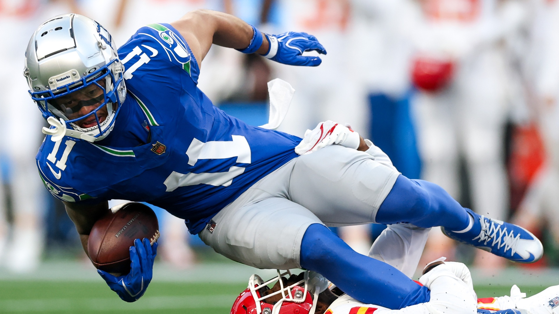 Jaxon Smith-Njigba of the Seattle Seahawks is tackled by L'jarius Sneed of the Kansas City Chiefs