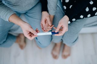 Couple holding a pregnancy test