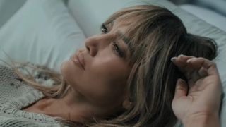 Jennifer Lopez laying down in This Is Me...Now: A Love Story