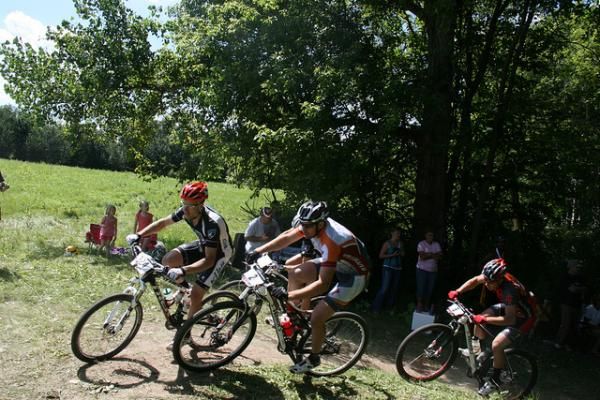 Darrin Braun (Adventure 212/Specialized), center and Ben Koenig (RMC / Red Eye Brewery), right, give chase at the crest of the start climb.