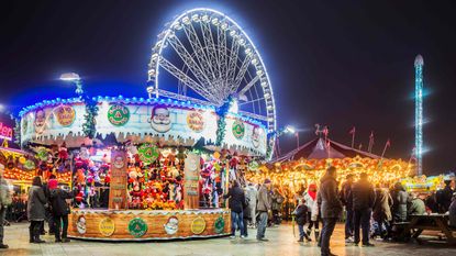 A nighttime view of a busy amusement park.