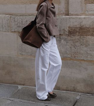 Influencer wears a brown suede bag.