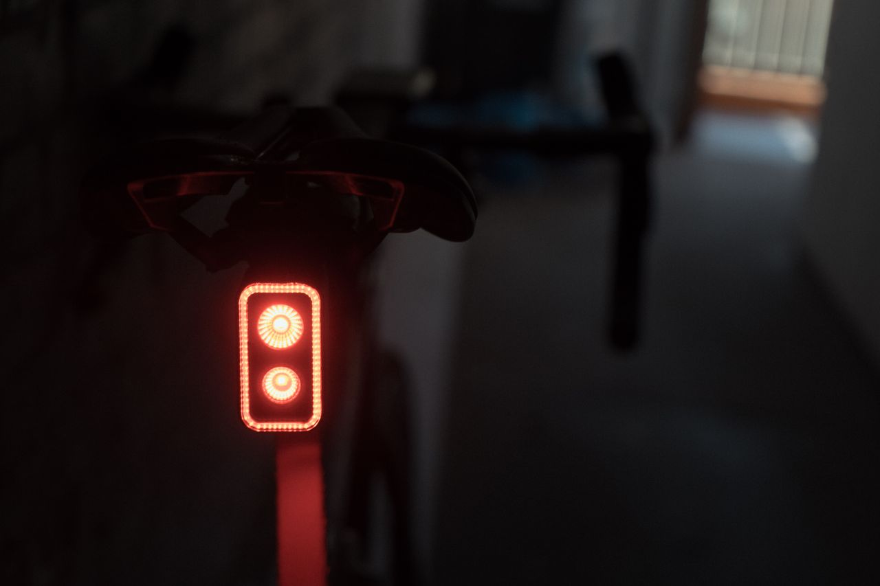A close up of a rear bike light with two bulbs