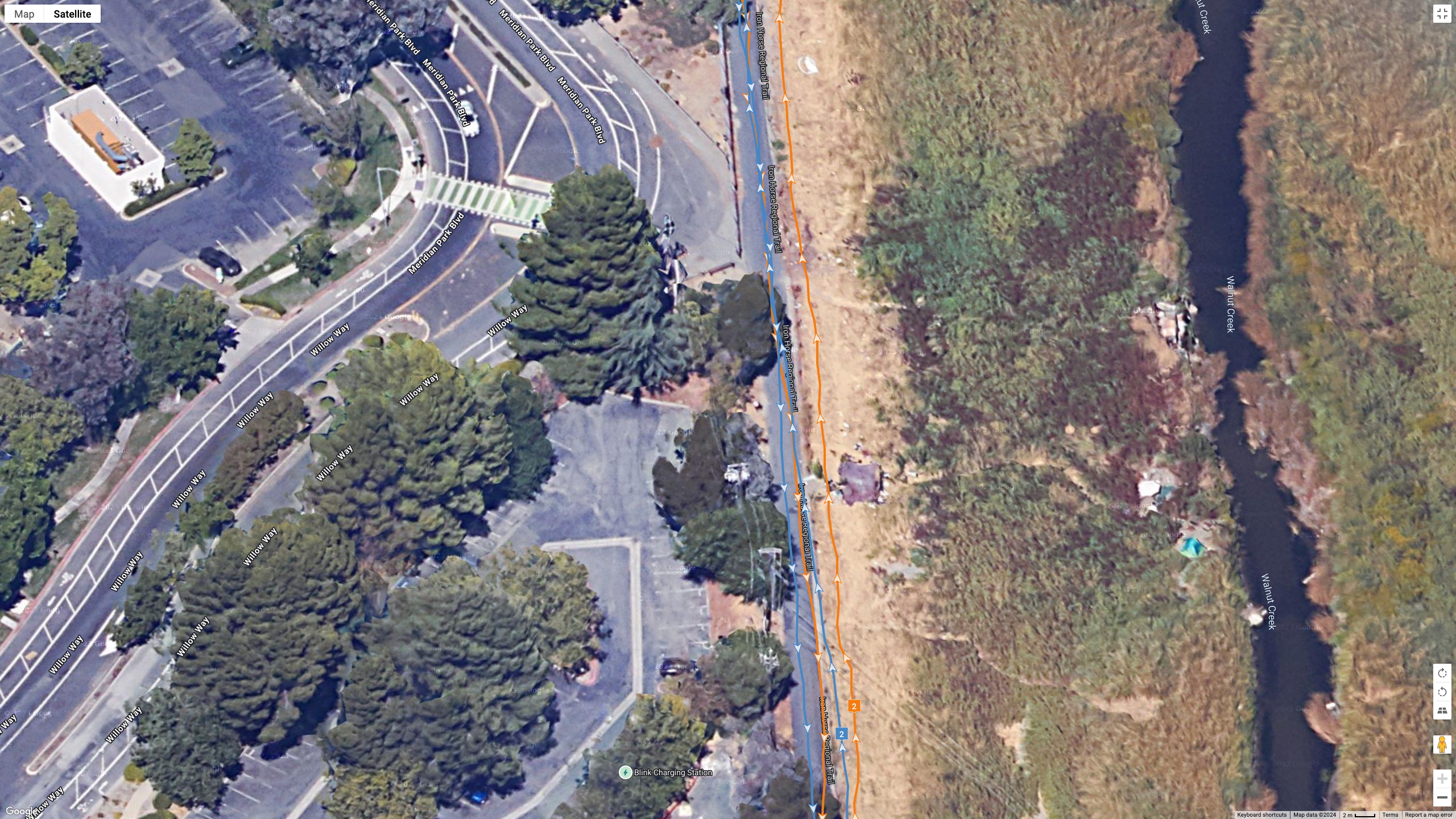 A Google Maps satellite view showing how the Polar Vantage M3 (orange line) and Garmin Fenix 8 (blue line) compared for GPS accuracy during a run.