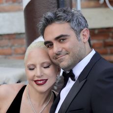 Lady Gaga smiles while hugging fiance Michael Polansky on a boat at the 81st Venice International Film Festival on September 04, 2024