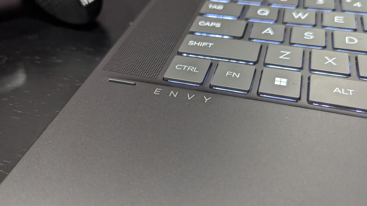 Close-up photo of Envy logo below the keyboard of the HP Envy x360.