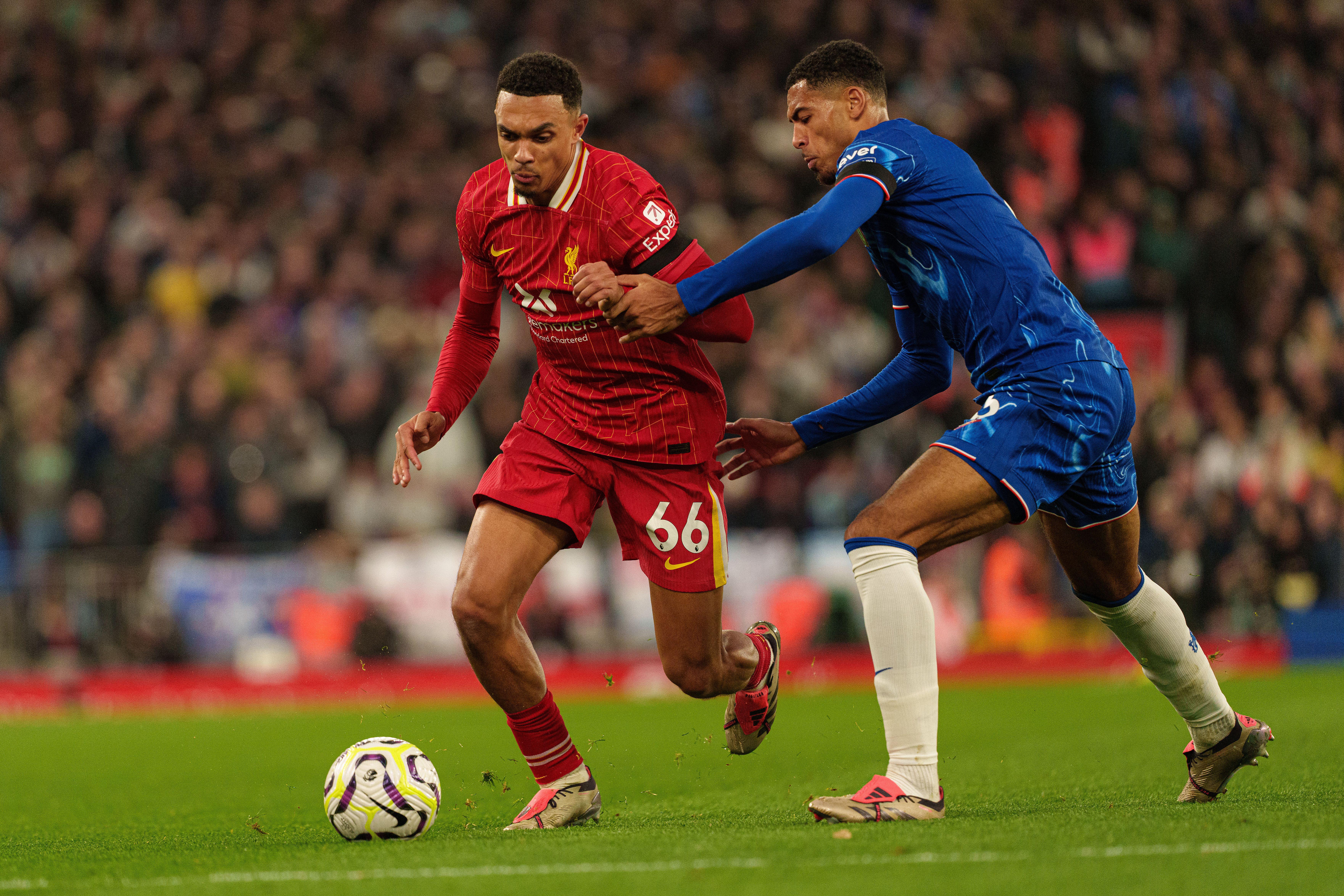 Liverpool's Trent Alexander-Arnold and Chelsea's Levi Colwill battle for the ball, October 2024.