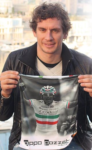 Filippo Pozzato shows the special pouch made by Scicon to help Italian flood victims
