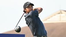 Charlie Woods holds his finish on a drive at the Junior PGA Championship
