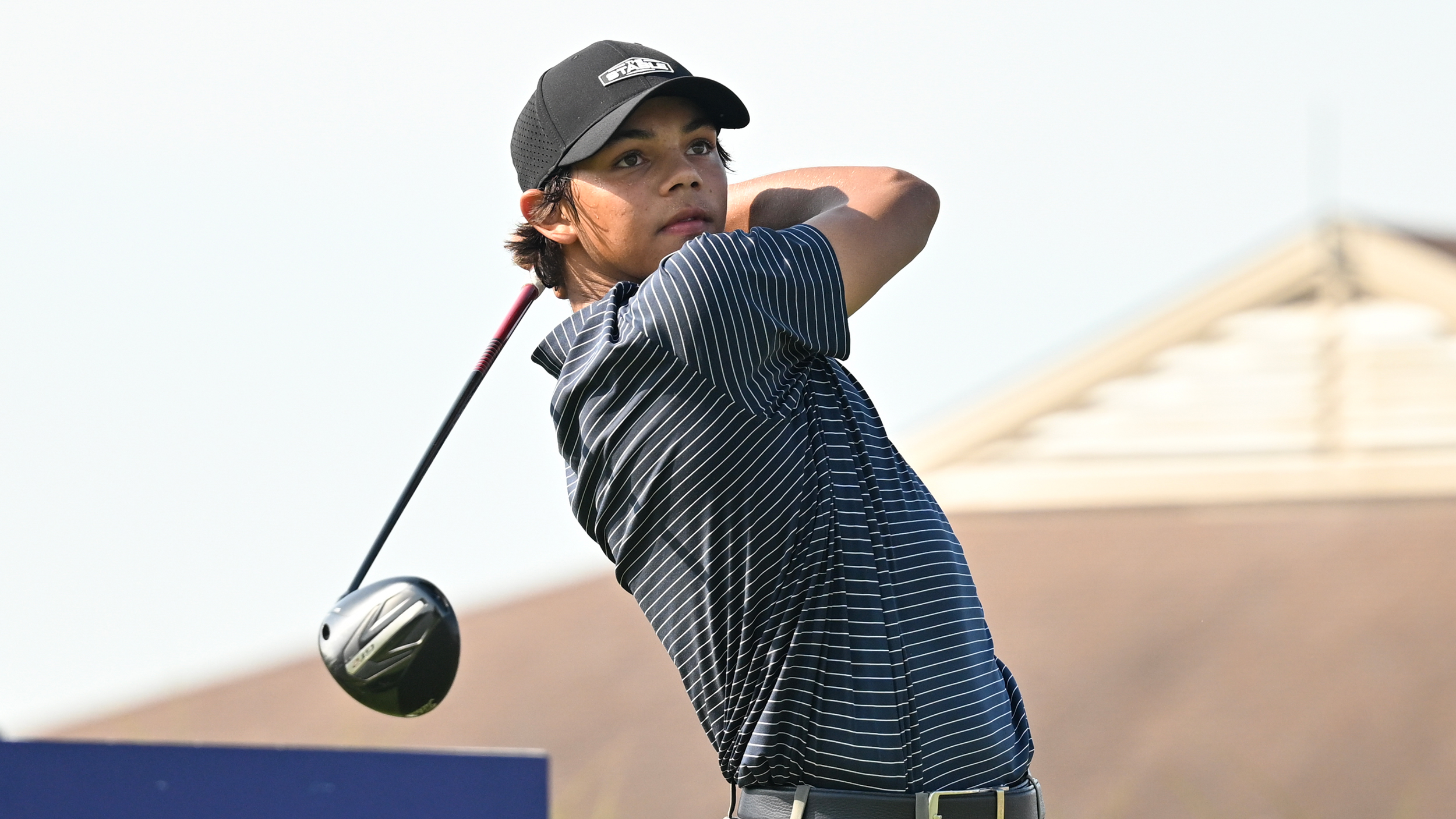 Charlie Woods holds his finish on a drive at the Junior PGA Championship