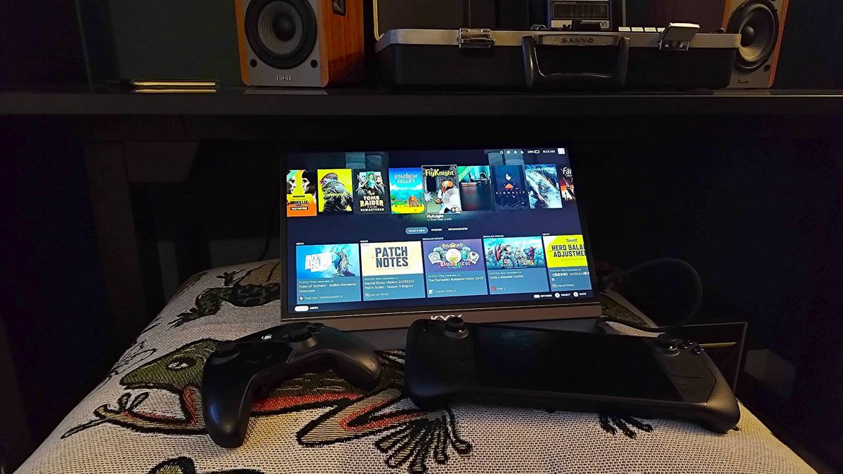 KYY Portable Monitor next to Steam Deck OLED and controller on top of blanket.