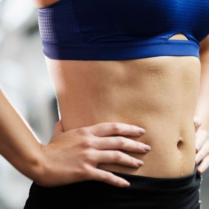 A woman practicing standing core exercises