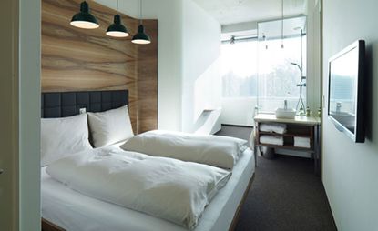 Rooms decorated in shades of grey and white, with concrete ceilings, offer fabulous views across Vienna.