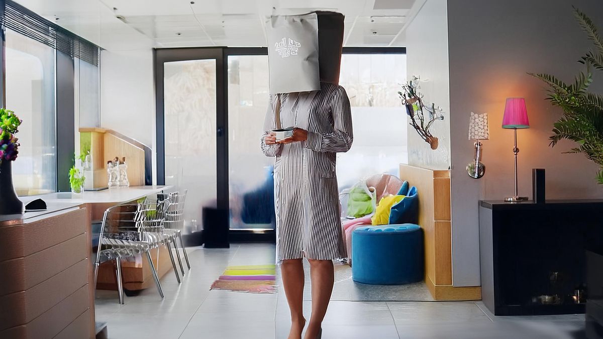 Woman hiding from camera with bag on head