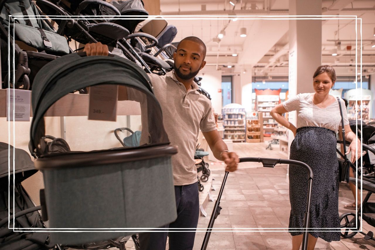 A mixed race pregnant couple shopping for baby supplies