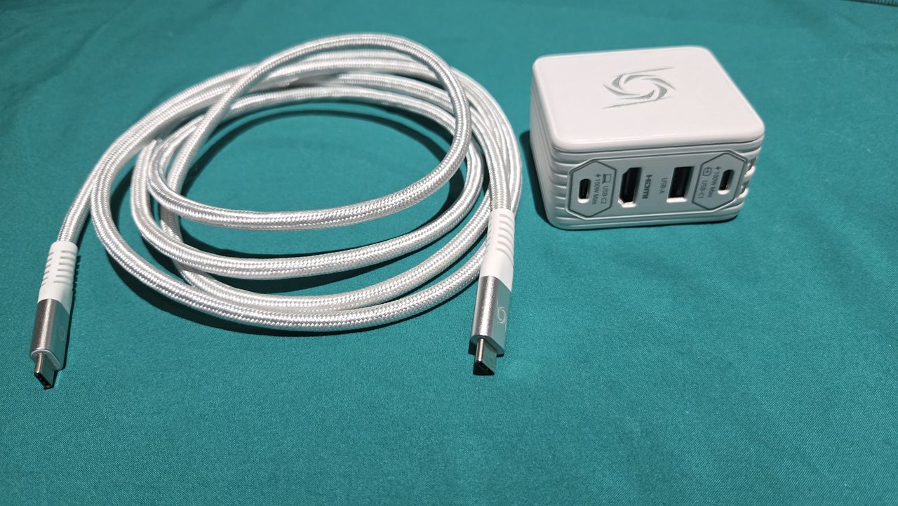 AVerMedia Elite Go GC313Pro on a turquoise sheet with cables.