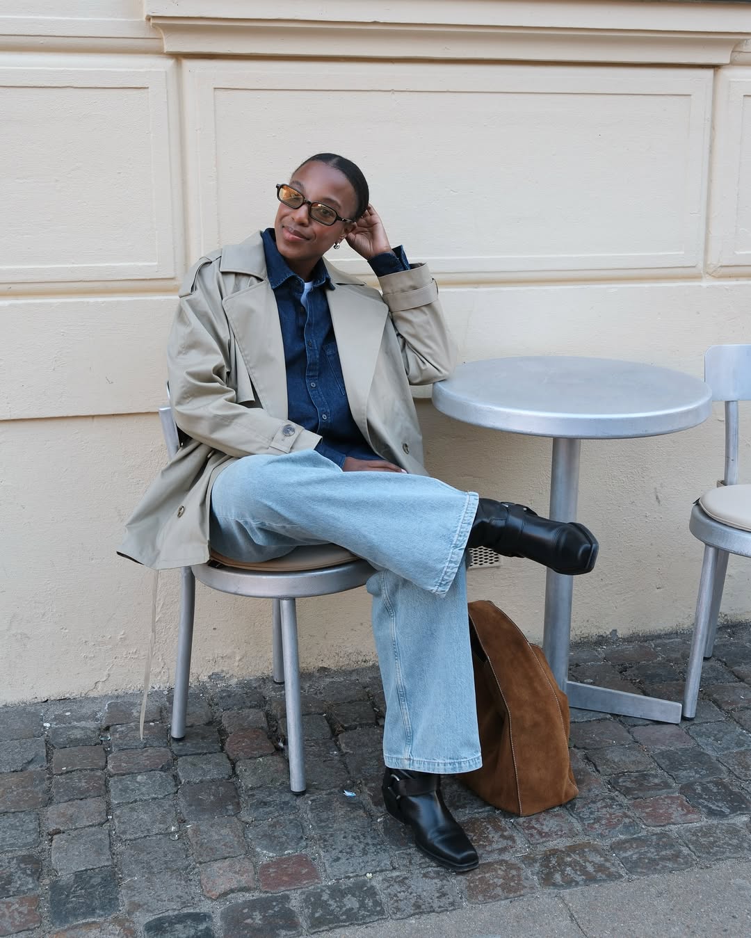 @taffymsipa wears blue jeans, black biker boots, trench coat