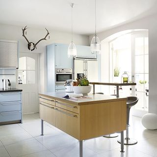 kitchen with white tiles flooring and cabinets