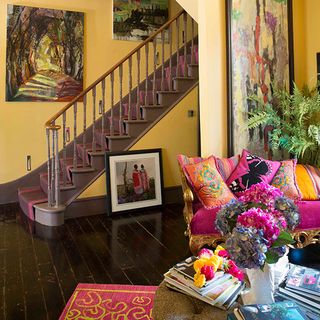 living area with stair case and yellow wooden floor