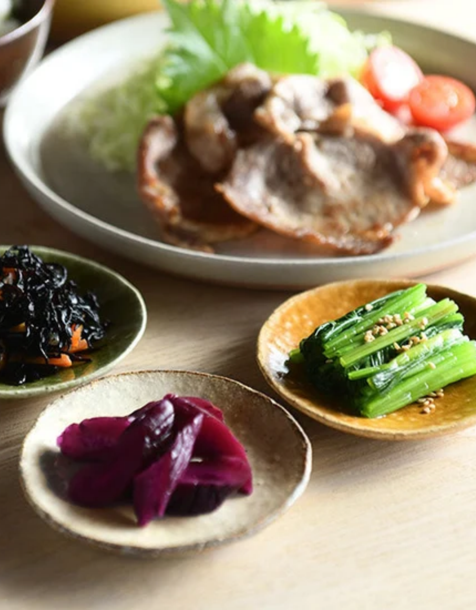 A table set with colorful dishes in ceramic bowls