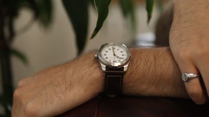 The Hamilton Khaki Field Expedition worn against a green and white background