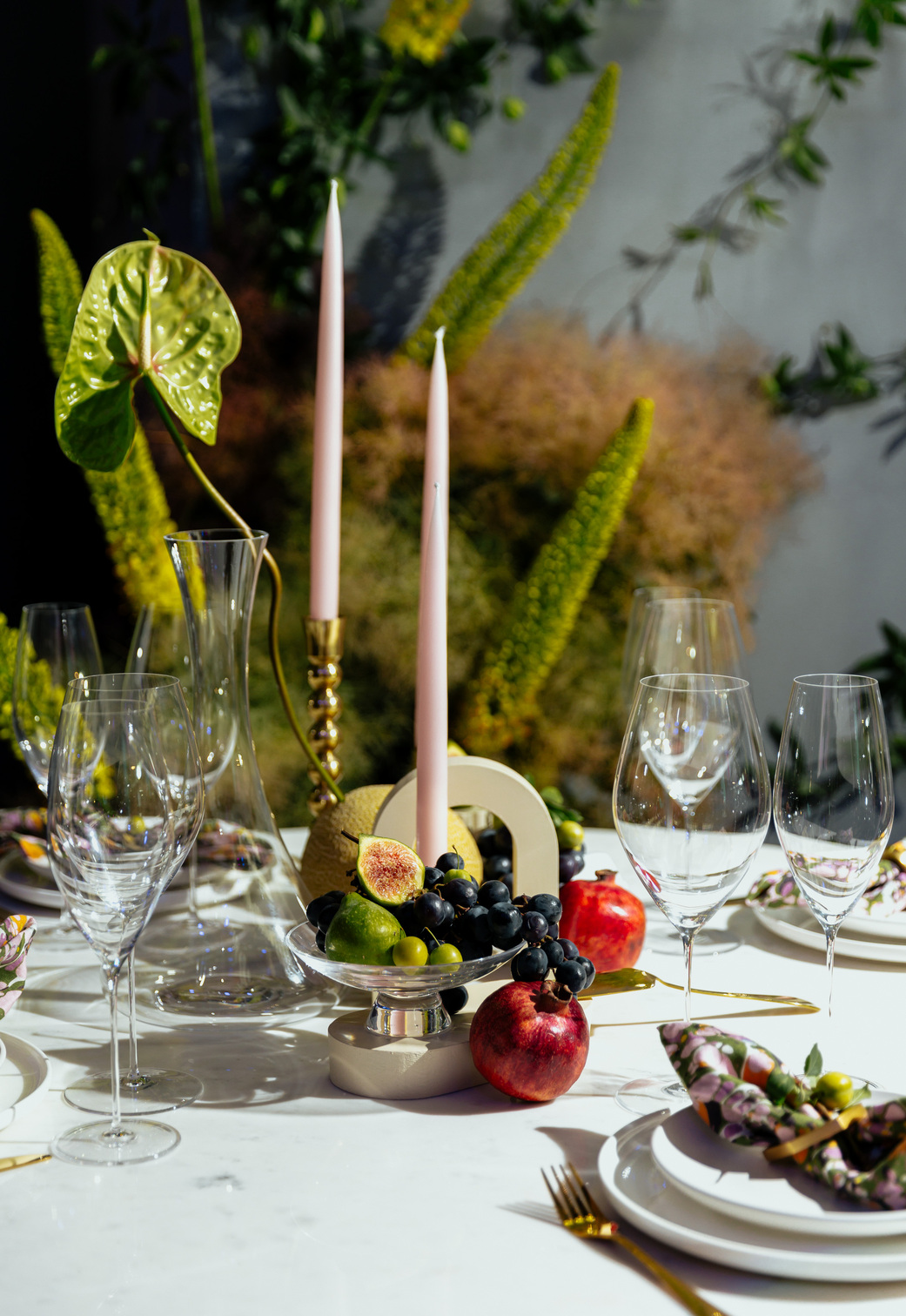 flowers on table setting with fruit and glassware