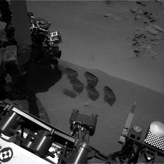 Bite-marks on Mars. NASA’s Mars rover Curiosity used a mechanism on its robotic arm to dig up five scoopfuls of material from a patch of dusty sand called “Rocknest.” Each of the pits is about 2 inches (5 centimeters) wide. A sample from that fifth scoop was analyzed by Curiosity’s Sample Analysis at Mars (SAM) suite of instruments inside the rover. A second sample from the same scoopful of material was delivered to SAM for analysis on Sol 96 (Nov. 12).