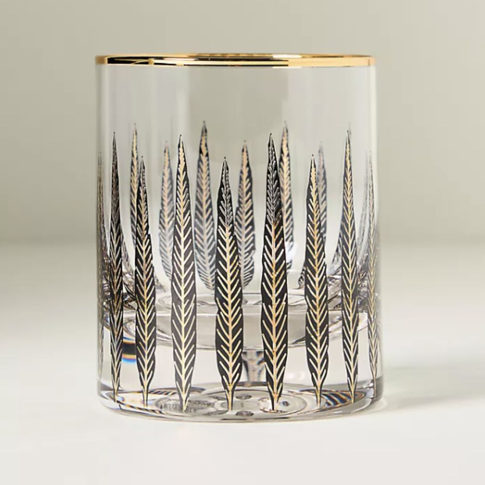 Glass tumbler with black and gold feather decal