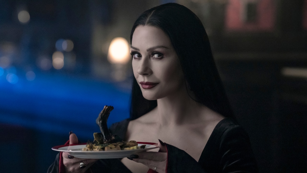 Morticia holding food plate in Wednesday Season 2