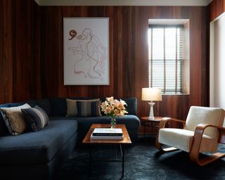 seating area with mid century furniture and wooden walls