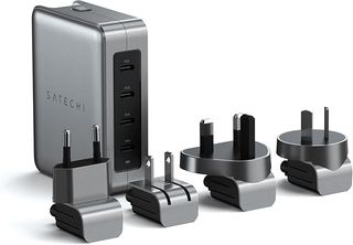 Four plugs lined up in front of a Satechi GaN Travel Charger