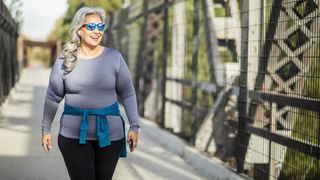 Woman walking over bridge