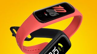 Two Samsung Galaxy Fit 2 fitness trackers on an orange background