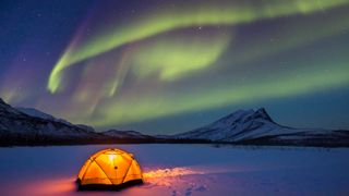 Aurora borealis above camping tent