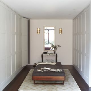white walls with wooden flooring and white door